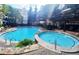 Beautiful community pool and hot tub area framed by trees, lounge chairs and meticulously maintained landscaping at 1850 Cotillion Dr # 3123, Dunwoody, GA 30338