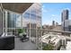 A modern balcony showcases city views with a cozy seating area, perfect for relaxing and enjoying the scenery at 3325 Piedmont Ne Rd # 1801, Atlanta, GA 30305