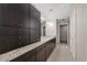 Spacious bathroom features dual sinks, granite countertops, dark wood cabinetry, and tile floors at 3325 Piedmont Ne Rd # 1801, Atlanta, GA 30305