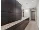 Spacious bathroom features dual sinks, granite countertops, dark wood cabinetry, and tile floors at 3325 Piedmont Ne Rd # 1801, Atlanta, GA 30305