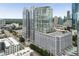 Striking high-rise building with glass facade, surrounded by city skyline, trees, and streets at 3325 Piedmont Ne Rd # 1801, Atlanta, GA 30305
