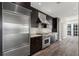 Modern kitchen featuring stainless steel appliances, granite countertops, and dark wood cabinetry at 3325 Piedmont Ne Rd # 1801, Atlanta, GA 30305