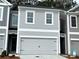 Charming two-story home with a gray exterior, garage, and well-maintained landscaping at 5142 Longview Run, Decatur, GA 30035