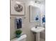 Modern bathroom with pedestal sink, decorative mirror, and stylish wall art at 3300 Windy Ridge Se Pkwy # 813, Atlanta, GA 30339
