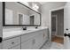 Double vanity bathroom with marble countertops and large mirror at 136 Rainey Rd, Temple, GA 30179