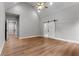 Large bedroom with vaulted ceiling, wood-look flooring, and barn door at 136 Rainey Rd, Temple, GA 30179