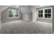 Bright and airy bonus room with carpet flooring and multiple windows at 136 Rainey Rd, Temple, GA 30179