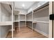 Spacious walk-in closet with built-in shelves and hanging rods at 136 Rainey Rd, Temple, GA 30179