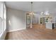 Bright dining room features hardwood floors and a stylish chandelier at 136 Rainey Rd, Temple, GA 30179