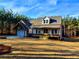 White farmhouse with stone accents and a welcoming front porch at 136 Rainey Rd, Temple, GA 30179