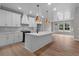 Modern kitchen with white cabinets, quartz countertops, and a large island at 136 Rainey Rd, Temple, GA 30179