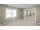 Bright living room with neutral walls, carpet, and mirrored accent wall at 5620 Orly Ter, College Park, GA 30349