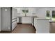 Bright updated kitchen boasts white cabinets, stainless appliances, and granite countertops at 4340 W Linda Dr, Douglasville, GA 30134