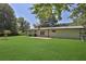 Large backyard with lush green grass and mature trees at 4340 W Linda Dr, Douglasville, GA 30134