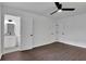 Spacious bedroom with dark laminate flooring and access to bathroom and closets at 4340 W Linda Dr, Douglasville, GA 30134