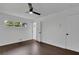 Bright bedroom with ceiling fan, dark laminate flooring, and access to bathroom at 4340 W Linda Dr, Douglasville, GA 30134