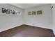 Spacious bedroom with dark brown laminate flooring and multiple windows at 4340 W Linda Dr, Douglasville, GA 30134