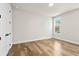 Light and airy bedroom with hardwood floors and window at 495 Pearl St, Cumming, GA 30040