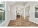Bright dining room with hardwood floors and view into kitchen at 495 Pearl St, Cumming, GA 30040