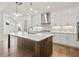 Modern kitchen with white cabinets and a large island at 495 Pearl St, Cumming, GA 30040