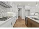 Modern kitchen with white cabinets and gas cooktop at 495 Pearl St, Cumming, GA 30040