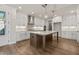 Modern kitchen with white cabinets and island at 495 Pearl St, Cumming, GA 30040