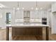 Modern kitchen with white cabinets, quartz countertops, and island at 495 Pearl St, Cumming, GA 30040