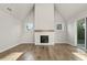 Living room with hardwood floors, fireplace, and sliding doors at 495 Pearl St, Cumming, GA 30040