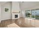 Living room with hardwood floors, fireplace, and backyard access at 495 Pearl St, Cumming, GA 30040