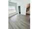 Bright bedroom with hardwood floors, closet, staircase, and a large window with natural light at 4440 Sims Park Overlook, Suwanee, GA 30024