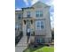 Beautiful townhome with brick facade, adorned with a welcoming wreath, and a well-maintained front yard at 4440 Sims Park Overlook, Suwanee, GA 30024