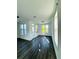 Bright living room featuring hardwood flooring, crown molding, lots of windows, and a glass door to the outside at 4440 Sims Park Overlook, Suwanee, GA 30024