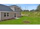 Charming backyard showcasing a well-maintained lawn and stylish stone and brick exterior at 570 Silver Moon Dr, Loganville, GA 30052