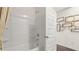 Bathroom featuring a shower-tub combo with white tile surround, shower head, and silver fixtures at 570 Silver Moon Dr, Loganville, GA 30052