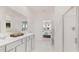 Bathroom featuring double sink vanity, white cabinets, and view to Primary at 570 Silver Moon Dr, Loganville, GA 30052