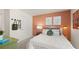 Cozy bedroom featuring stylish decor, an eye-catching accent wall, and natural lighting at 570 Silver Moon Dr, Loganville, GA 30052