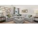 Spacious living room features a large sectional sofa, decorative pillows, and modern decor at 570 Silver Moon Dr, Loganville, GA 30052