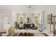 Open living room with stylish decor, neutral color palette, and large windows overlooking the landscaped outdoors at 570 Silver Moon Dr, Loganville, GA 30052