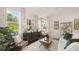 Bright living room with modern decor, stylish furniture, and large windows providing ample natural light at 570 Silver Moon Dr, Loganville, GA 30052