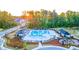 Aerial view of community pool featuring lounge area, picnic shelter, playground, and manicured landscaping at 570 Silver Moon Dr, Loganville, GA 30052