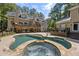 Stunning backyard with a stone pool and hot tub, and a view of the home's multiple decks at 2010 Stonehedge Rd, Roswell, GA 30075
