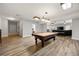 Finished basement with pool table and laminate flooring at 2010 Stonehedge Rd, Roswell, GA 30075