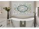 Bathroom features a freestanding tub, a large stained-glass window, and modern fixtures at 2010 Stonehedge Rd, Roswell, GA 30075