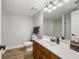 Neutral bathroom featuring a wood vanity, white countertops, and a tiled shower at 2010 Stonehedge Rd, Roswell, GA 30075