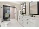 Modern bathroom with glass shower, double vanity, and sleek fixtures at 2010 Stonehedge Rd, Roswell, GA 30075