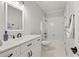 Bright bathroom features white cabinets, a tiled shower, and modern fixtures at 2010 Stonehedge Rd, Roswell, GA 30075