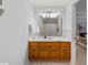 Cozy bathroom with wood cabinets, soft white walls and full mirror at 2010 Stonehedge Rd, Roswell, GA 30075