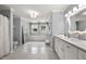 Large bathroom with double vanity, tiled floors, and natural light from two windows at 2010 Stonehedge Rd, Roswell, GA 30075