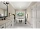 Bathroom features a freestanding tub, a large stained-glass window, and modern fixtures at 2010 Stonehedge Rd, Roswell, GA 30075