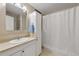 Functional bathroom with a white shower curtain and storage cabinet at 2010 Stonehedge Rd, Roswell, GA 30075